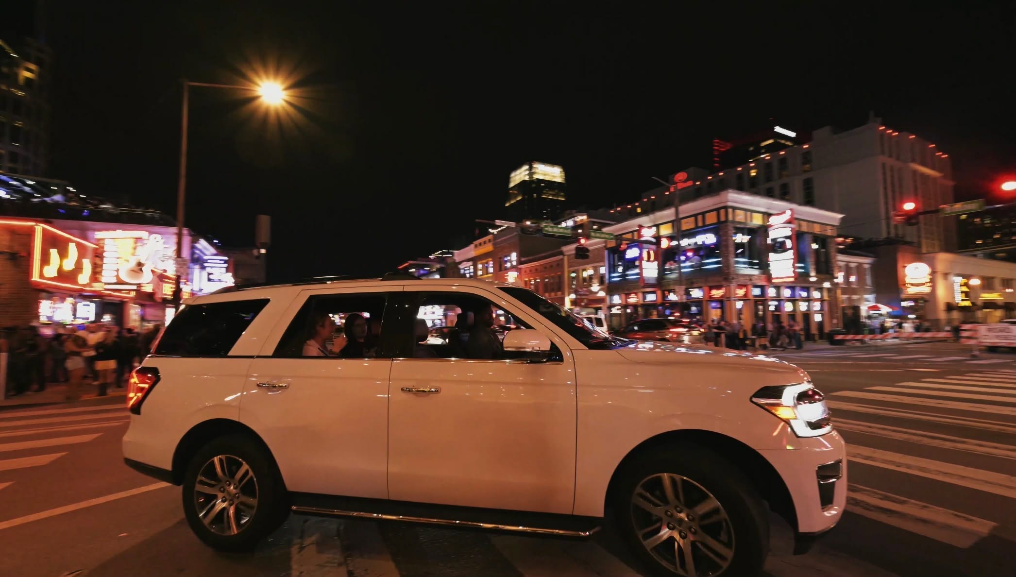 Luxury vehicle parked in a secure urban setting at night